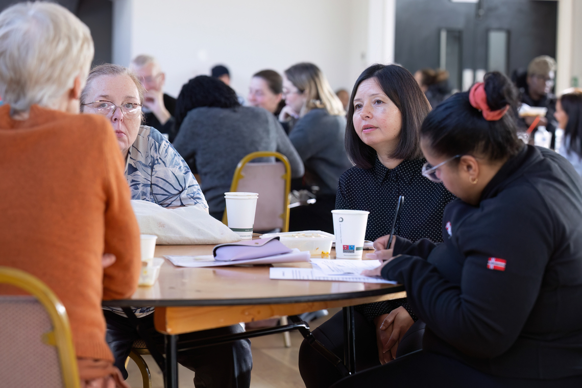 A group of people around a table at MVM 