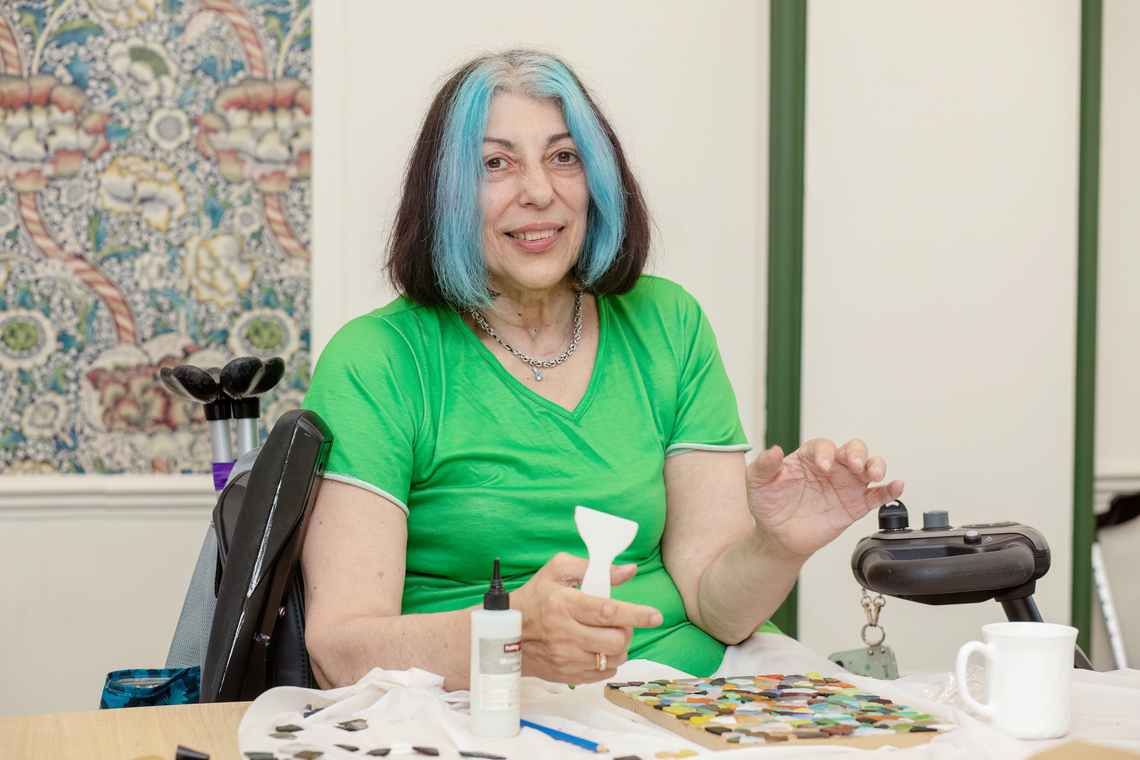Gina Vettese at Craftivism and Chat with Mosaic Materials in front of her